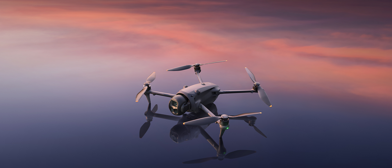 Camera drone flying at sunset